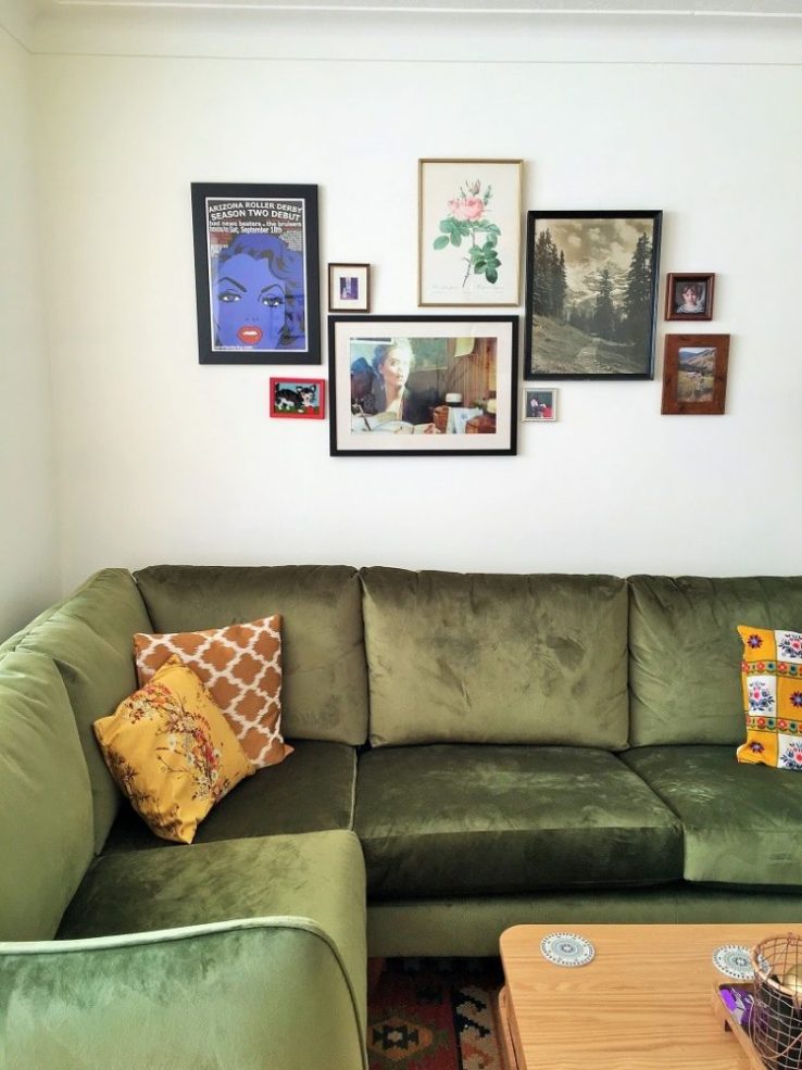 gallery wall bohemian living room with green velvet corner sofa