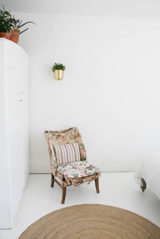 old chair white walls and hanging plants in bedroom